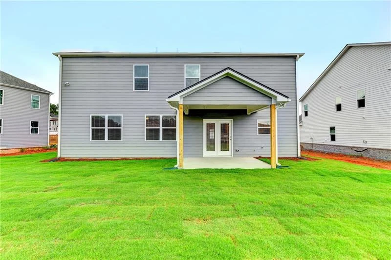 Rear exterior with covered patio and lawn